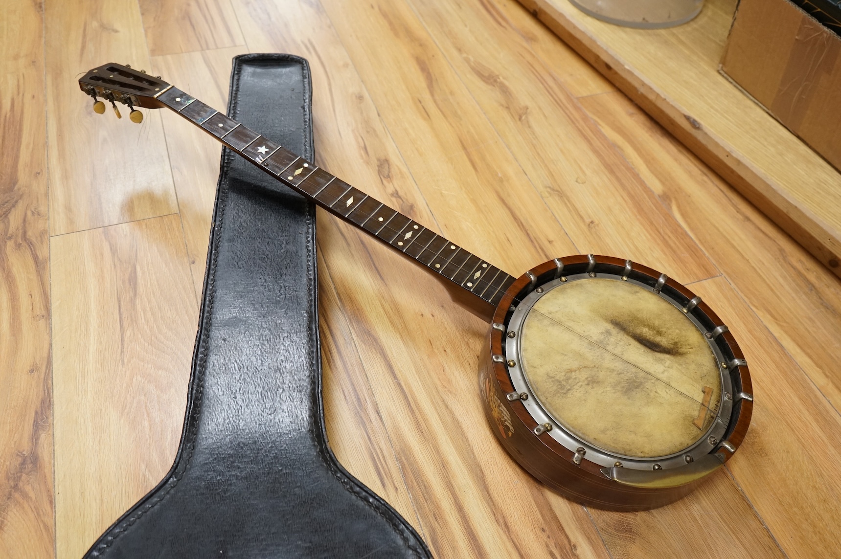 A rosewood banjo with mother of pearl inlay, cased